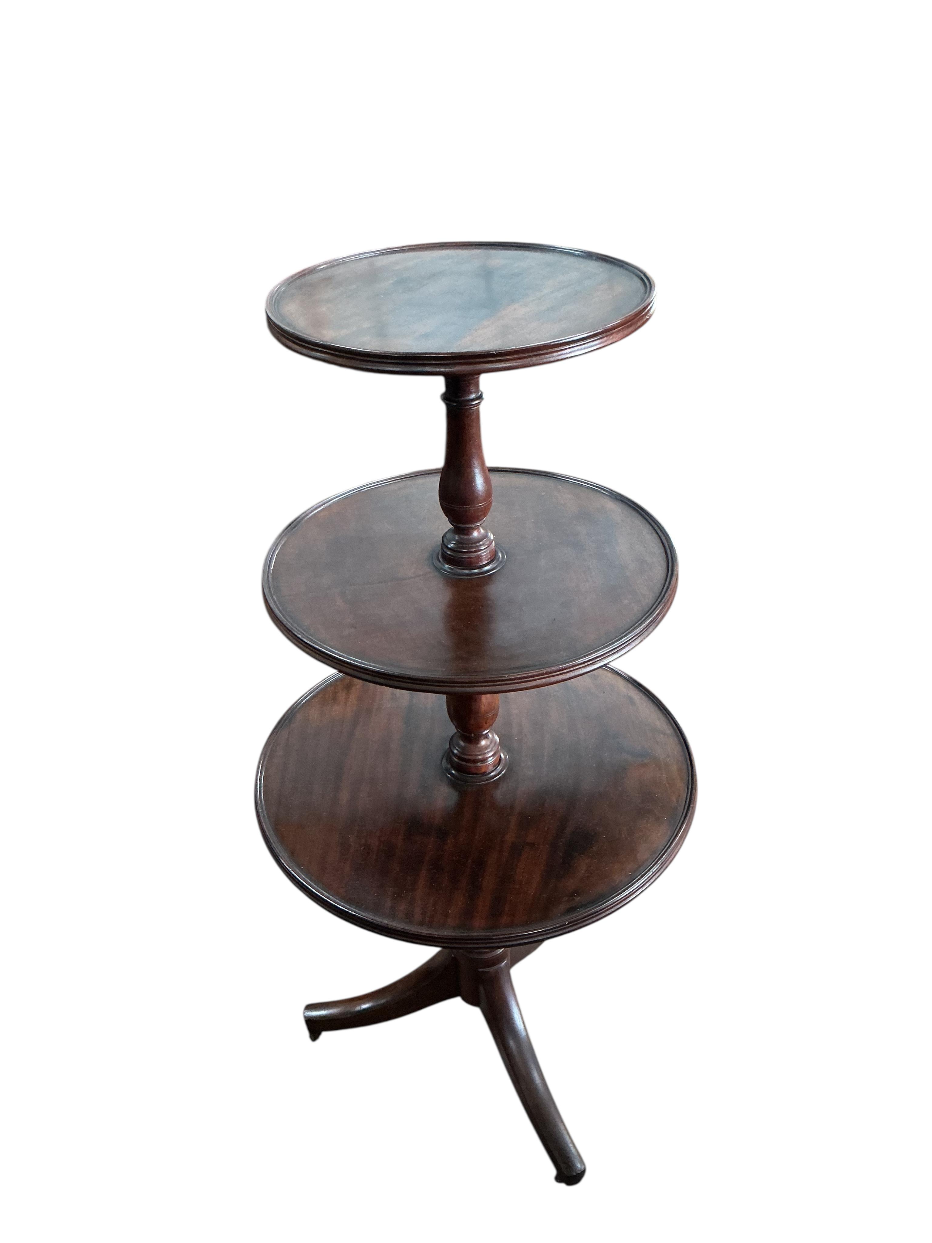 A Regency mahogany graduated three tier dumb waiter, height 125cm